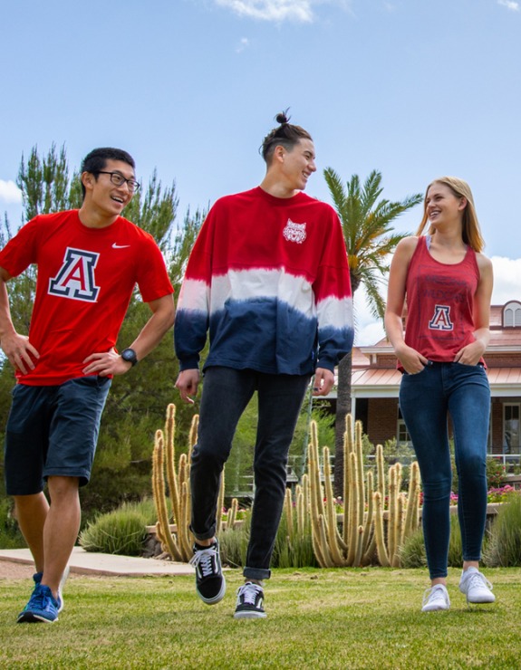students on campus with UArizona gear on
