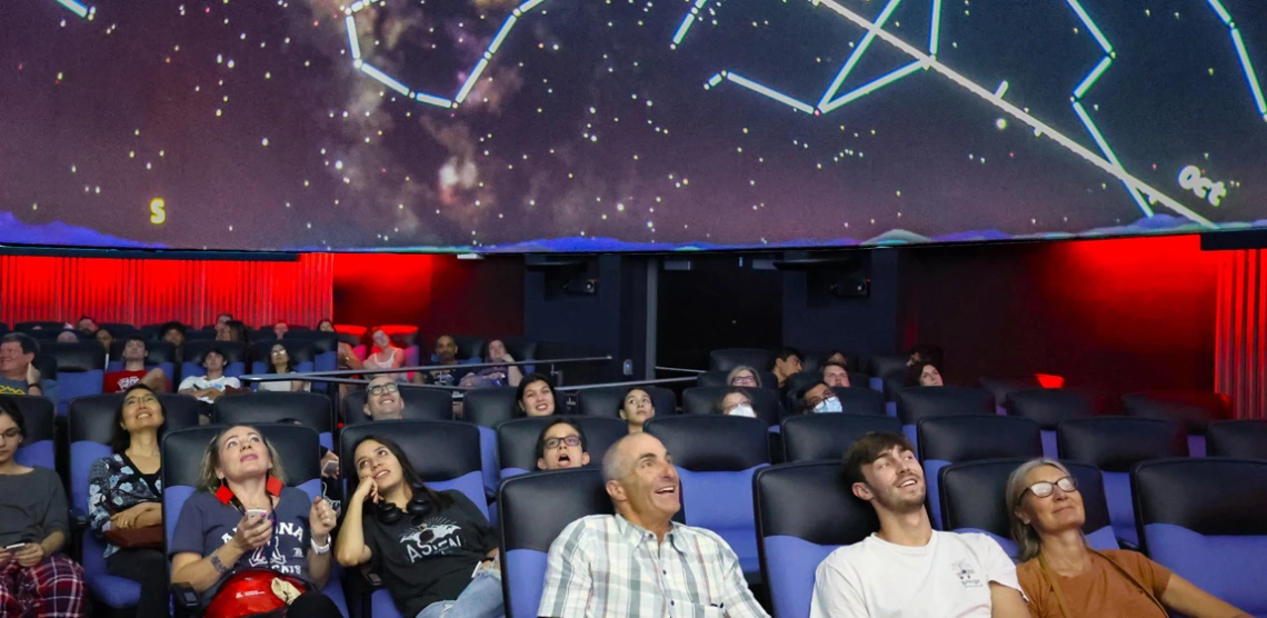 Families enjoying a multimedia experience in UArizona Flandrau Planetarium