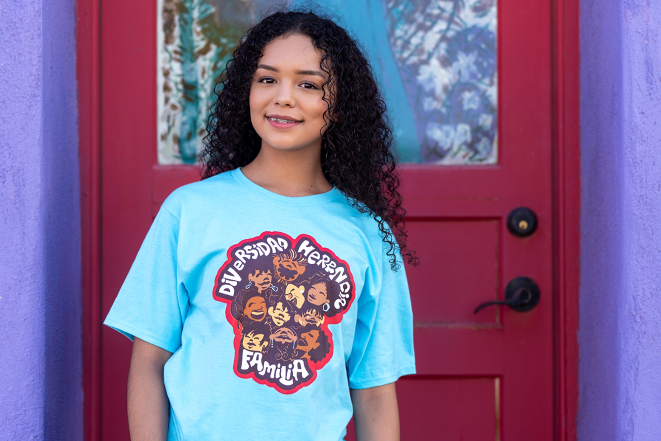 Woman wearing Hispanic Heritage clothing outside of a red door